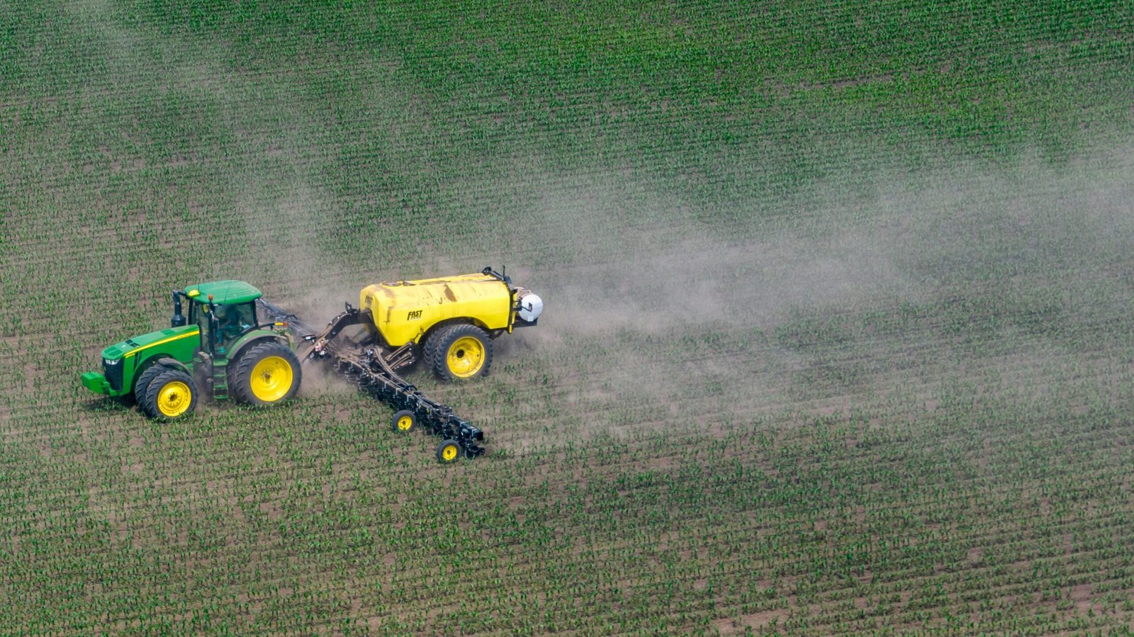 tractor en campo de agricultura abierta fertilizando